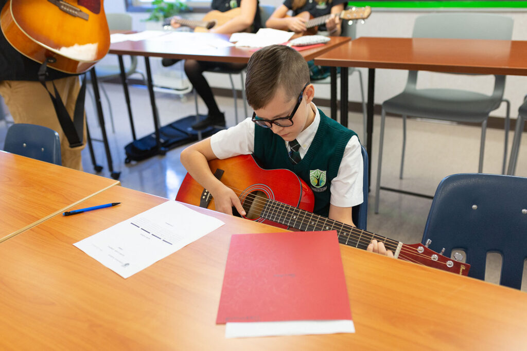 willowstone academy private school kelowna middle year student playing guitar